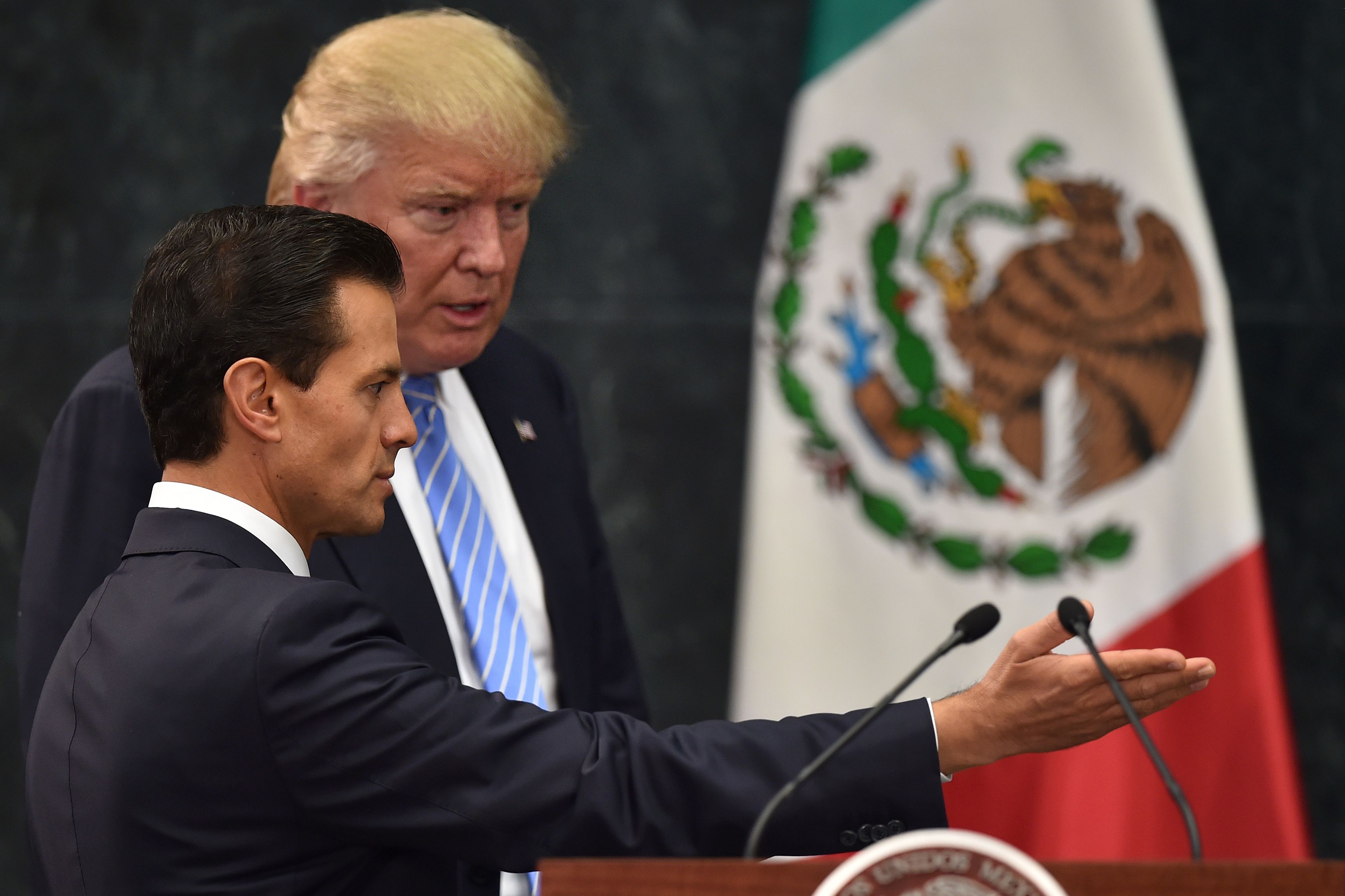US presidential candidate Donald Trump (R) and Mexican President Enrique Pena Nieto prepare to deliver a joint press conference in Mexico City on August 31, 2016. Donald Trump was expected in Mexico Wednesday to meet its president, in a move aimed at showing that despite the Republican White House hopeful's hardline opposition to illegal immigration he is no close-minded xenophobe. Trump stunned the political establishment when he announced late Tuesday that he was making the surprise trip south of the border to meet with President Enrique Pena Nieto, a sharp Trump critic. / AFP PHOTO / YURI CORTEZYURI CORTEZ/AFP/Getty Images ** OUTS - ELSENT, FPG, CM - OUTS * NM, PH, VA if sourced by CT, LA or MoD **